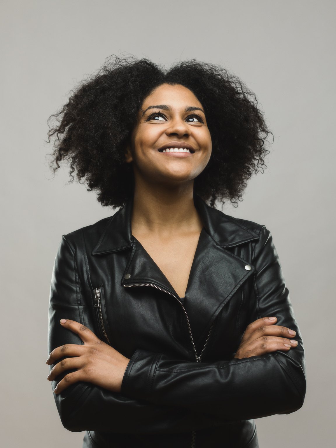 Cheerful black woman looking up and smiling